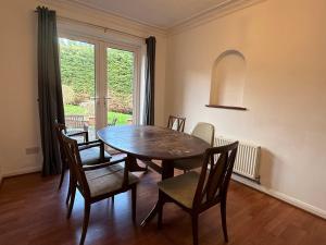a dining room with a table and chairs and a window at Large 4 Bed with Parking in Hillmorton