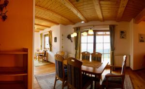 a kitchen and dining room with a table and chairs at Almhaus Karantanien in Hochrindl