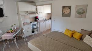 a living room with a couch and a table and a kitchen at Νέος Πύργος Family Home in Neos Pirgos