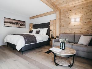 a bedroom with a bed and a couch at VAYA Nauders in Nauders +57 photos