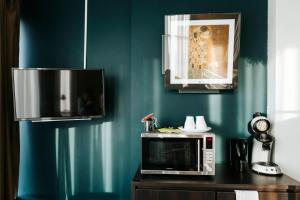 a microwave sitting on a counter in a kitchen at The Hague Teleport Hotel - Free Parking in The Hague