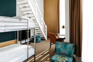 a dorm room with bunk beds and a desk at The Hague Teleport Hotel - Free Parking in The Hague