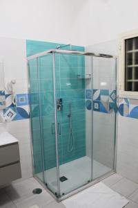 a shower with a glass door in a bathroom at Ada's House in Atrani +58 photos