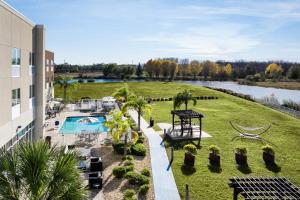 an aerial view of a resort with a pool and a yard at Holiday Inn Express & Suites Trinity by IHG in Trinity