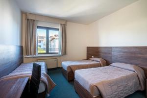 a hotel room with two beds and a window at Venice Hotel Albatros in Mestre +95 photos