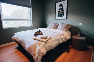 a bedroom with a bed with a teddy bear on it at Odda Apartments - 2BR & 3BR - Parking - T32 in Odda