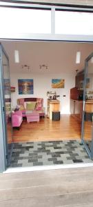 a living room with pink couches and a table at The Gallery Lodges in Braunton
