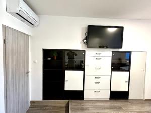 a living room with a tv on a wall at Rookos rooms in Ljubljana