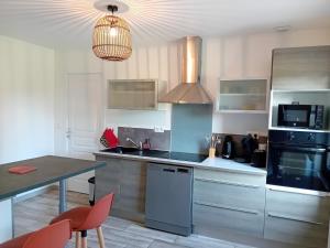 a kitchen with a sink and a stove top oven at Le gîte d'Elisa in Roullours