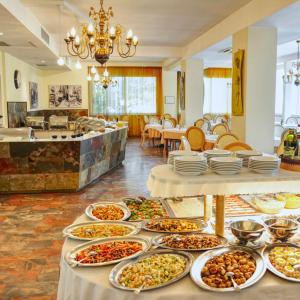 a buffet line with many different types of food at Hotel Riz in Cesenatico