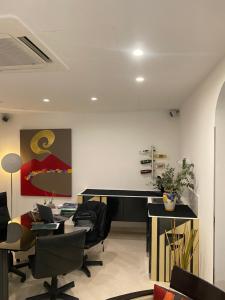 an office with a desk and chairs and a piano at Hotel Plebiscito Aparthotel in Naples