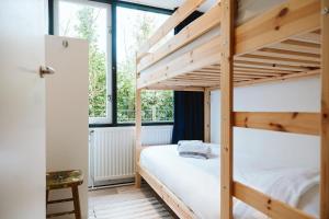 a bedroom with a bunk bed and a window at Jonkerstee 59 - Ouddorp in Ouddorp