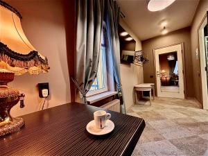 a coffee cup on a wooden table in a room at Best apartments Narva in Narva