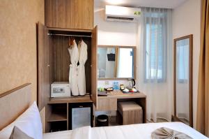 a bedroom with a bed and a desk in a room at Violet hotel 2 in Nha Trang