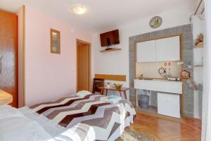a bedroom with two beds and a sink at Apartments Tasha in Štivan +12 photos