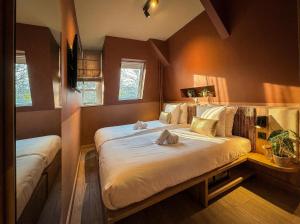 a bedroom with a bed with two towels on it at De Pijp Hotel in Amsterdam