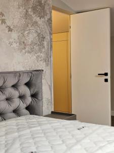 a bedroom with a bed and a yellow door at ISHotel in Craiova