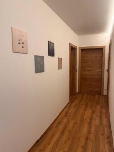 a room with white walls and a wooden door at Appartements Ehrensberger in Brixen im Thale +17 photos
