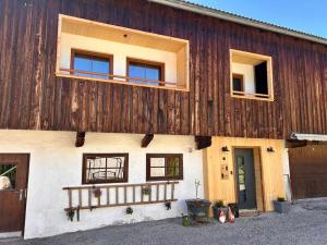 a large wooden building with windows and a balcony at Appartements Ehrensberger in Brixen im Thale