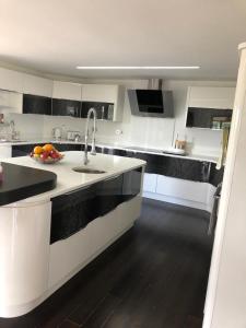 a kitchen with a sink and a bowl of fruit on the counter at The Walnut Retreat Castlewellan in Ballyward