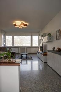 a living room with a couch and a table at Colli Apartment Lake Como in Malgrate