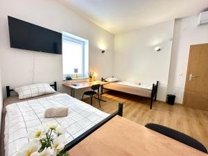 a bedroom with a bed and a table and a desk at Rookos rooms in Ljubljana
