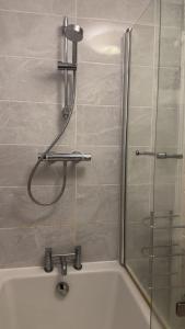 a bathroom with a shower and a bath tub at 40 Kennett gardens in Gloucester