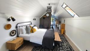 a bedroom with a bed and a clock on the wall at Lorraine Loft Apartment in Gqeberha
