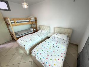 a bedroom with two beds and a bunk bed at Paradise View in Shkodër