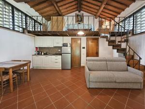 a living room with a couch and a table and a kitchen at Podere Raggio Di Sole in San Gimignano