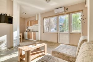 a living room with two couches and a table at Apartments Moskov in Kotor