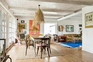 a dining room with a table and chairs at By The Bay A Thatched House Lies So Beautifully in Nørre Åby