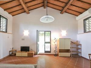 a large living room with a couch and a tv at Podere Raggio Di Sole in San Gimignano