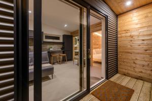a room with sliding glass doors leading to a bedroom at Killarney Glamping - Ross Road in Killarney +21 photos