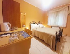 a hotel room with a bed and a table with a counter at Bed and Breakfast Rosangela in Taormina +30 photos