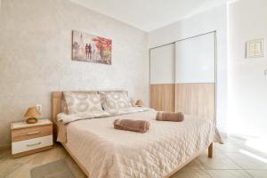 a bedroom with a bed and a large window at Apartments Moskov in Kotor