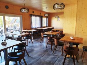 a dining room with wooden tables and chairs at PENZION PARMA in Ostružná