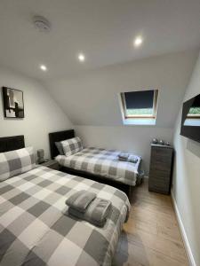 a bedroom with two beds in a attic at Apartment in Banff in Banff