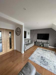a living room with a couch and a tv at Apartment in Banff in Banff +1 photo