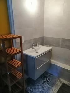 a bathroom with a white sink and a shelf at Chez Marine & Justine in Charolles +31 photos