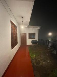 an empty room with a door and a window at saffronvilla in Haputale
