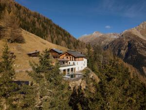 a building on the side of a mountain at Leni Mountain Chalet in Sölden