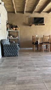 a living room with a table and a couch at Hospedaje Don Carmelo in El Peñón