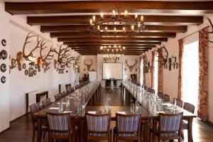a long conference room with a long table and chairs at Hubertus Hof Landhotel in Balatonfenyves +83 photos