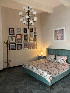 a bedroom with a bed and pictures on the wall at 3 Doni in Rabat