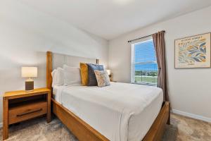 a bedroom with a bed and a window at 16148 Palm Frond Ave in Orlando +52 photos