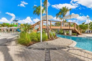 a bridge over a pool at a resort at 16148 Palm Frond Ave in Orlando