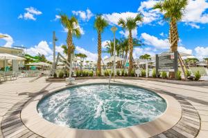 a pool at the resort with palm trees at 16148 Palm Frond Ave in Orlando