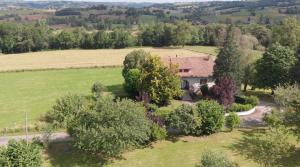 an aerial view of a house in a field with trees at L'Oustal in Saint-Constant