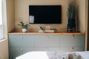 a living room with a tv on a wall at Odda Apartments - 2BR & 3BR - Parking - T32 in Odda